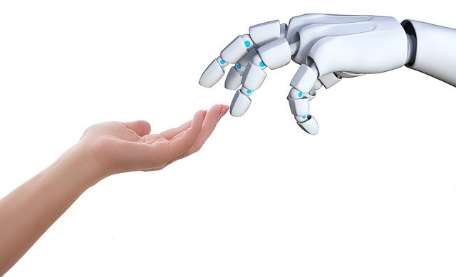 human hand touching a digital robot’s hand