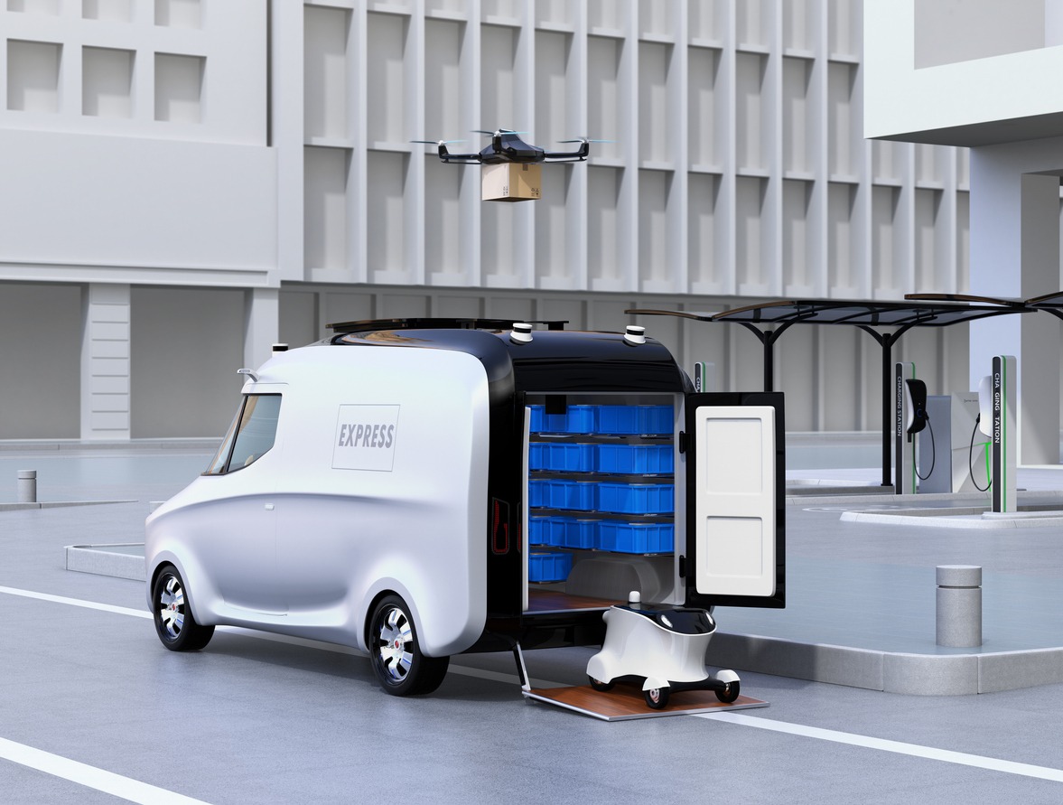 Fleet of self-driving delivery robots, van and drone at the side of road