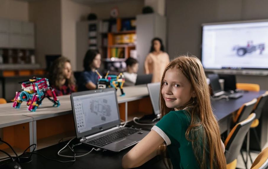 a girl using a laptop in a robotics class