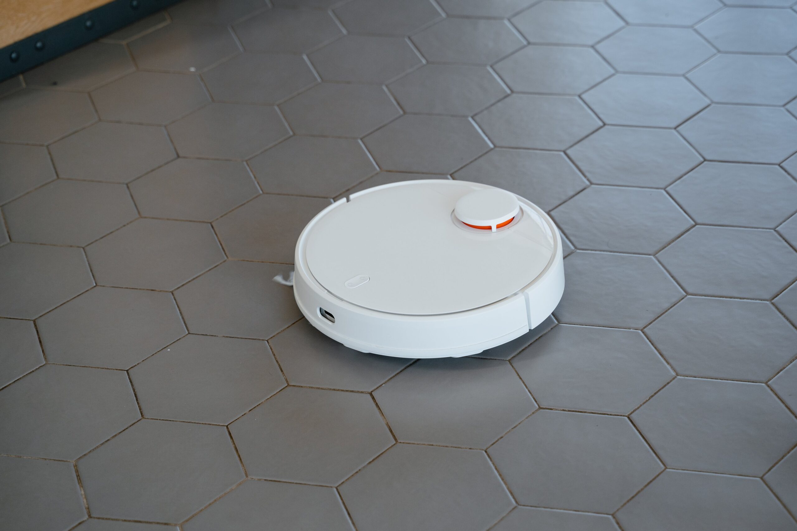 white round vacuum on gray tiles floor